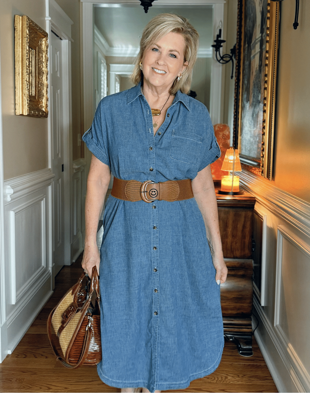 Woman over 50 in a belted chambray shirt dress